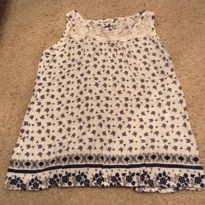 A purple, white, &dark blue flower pattern shirt